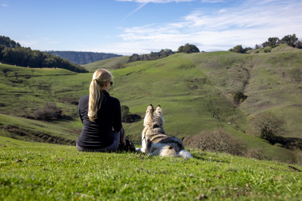 A woman walking her dog outdoors