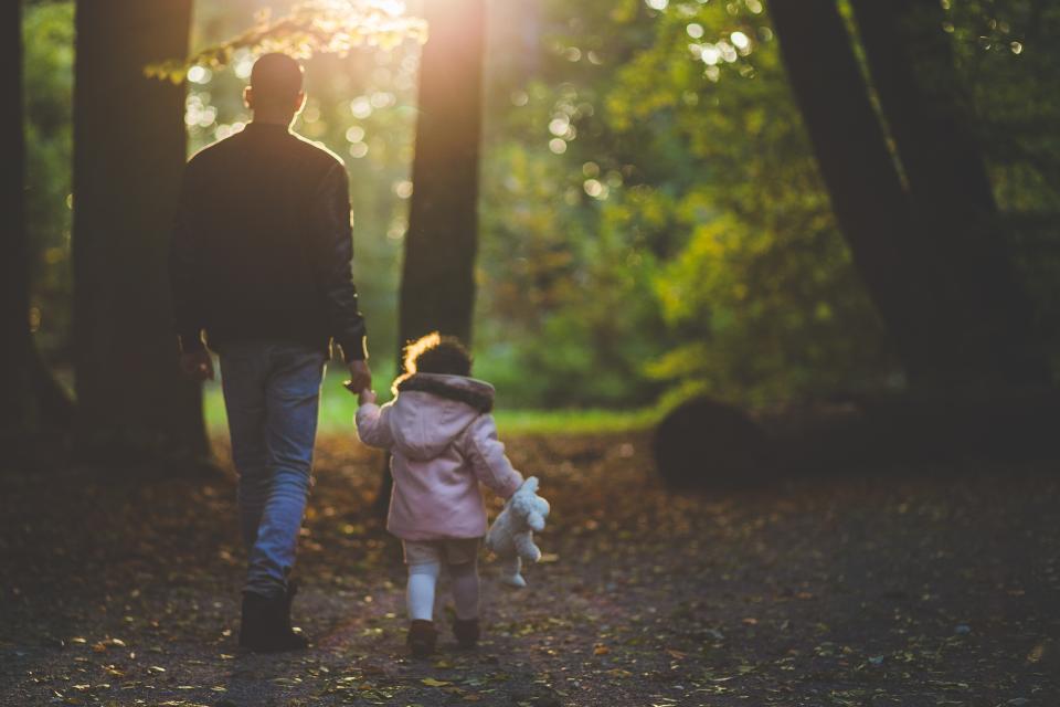 A parent and child walking in autumn